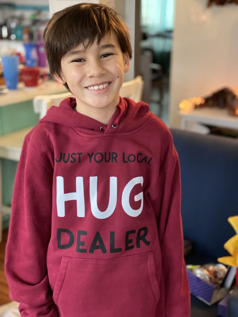 Adorable boy wearing a  DIY Just Your Local Hug Dealer hoodie. 