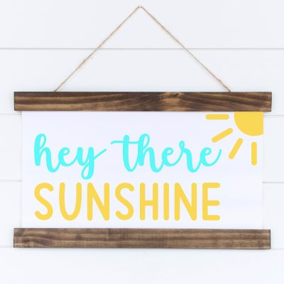 Spread a bit of crafty happiness with this free Hey There Sunshine Cut File! So cute for DIY signs and beach totes! Download all 12 free welcome sign svgs for crafting with your Cricut Maker, Cricut Explore Air 2, Cricut Joy or other cutting machine! Make great handmade housewarming gifts!