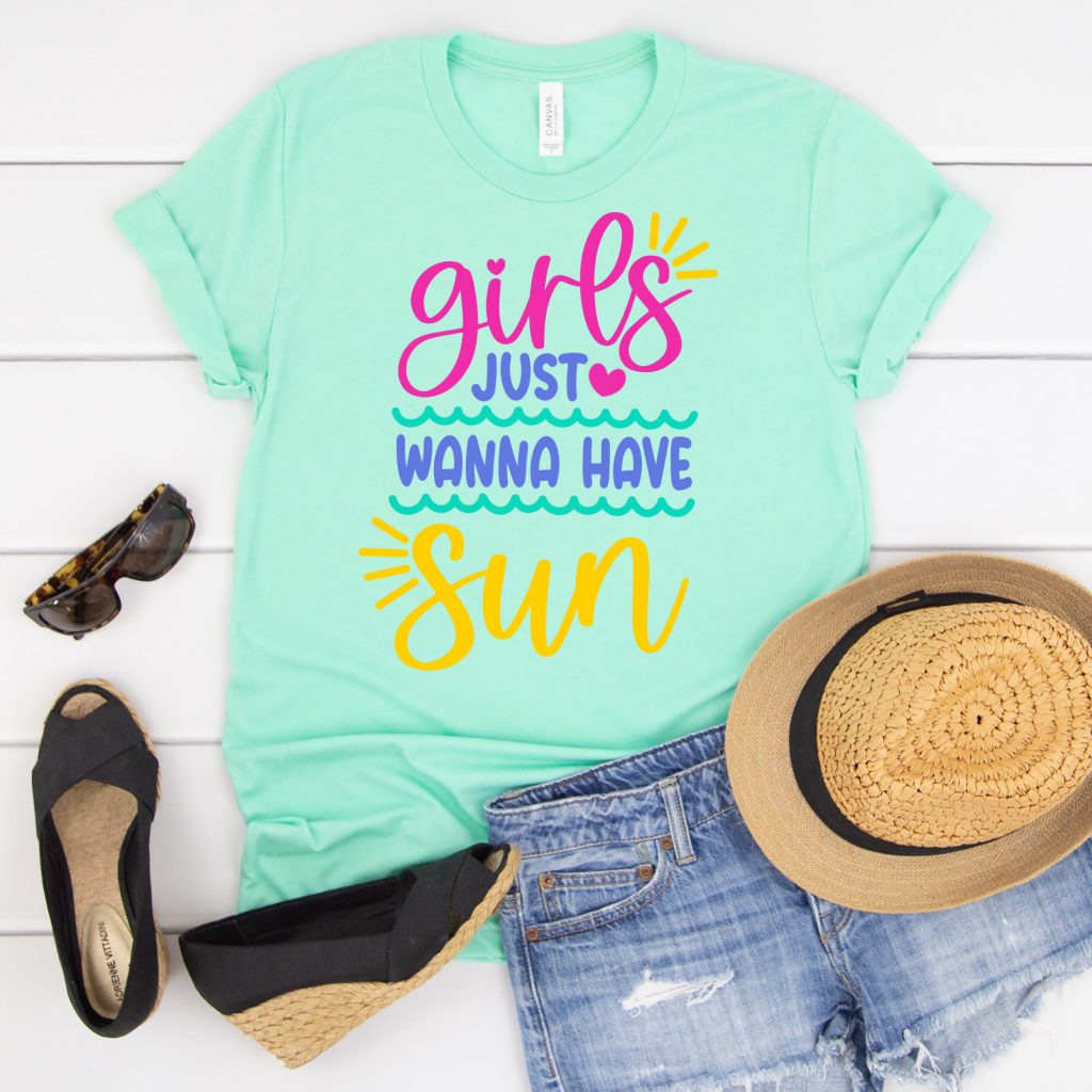 Teal shirt that says Girls Just Wanna Have Sun on the front. 